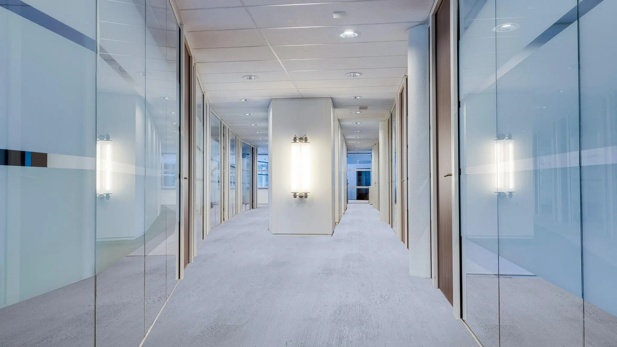 Moderne kantoorhal met glazen wanden en strakke verlichting aan de Euclideslaan.