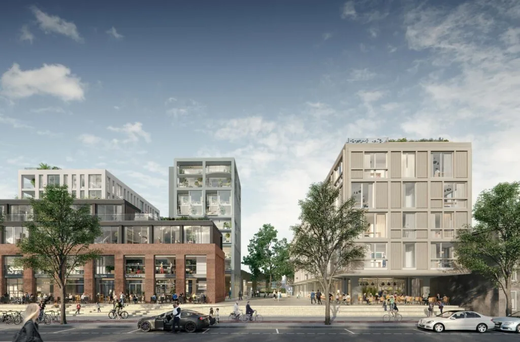 Moderne nieuwbouw aan de Papaverweg met appartementen, horeca en een levendige straat met voetgangers en fietsers.