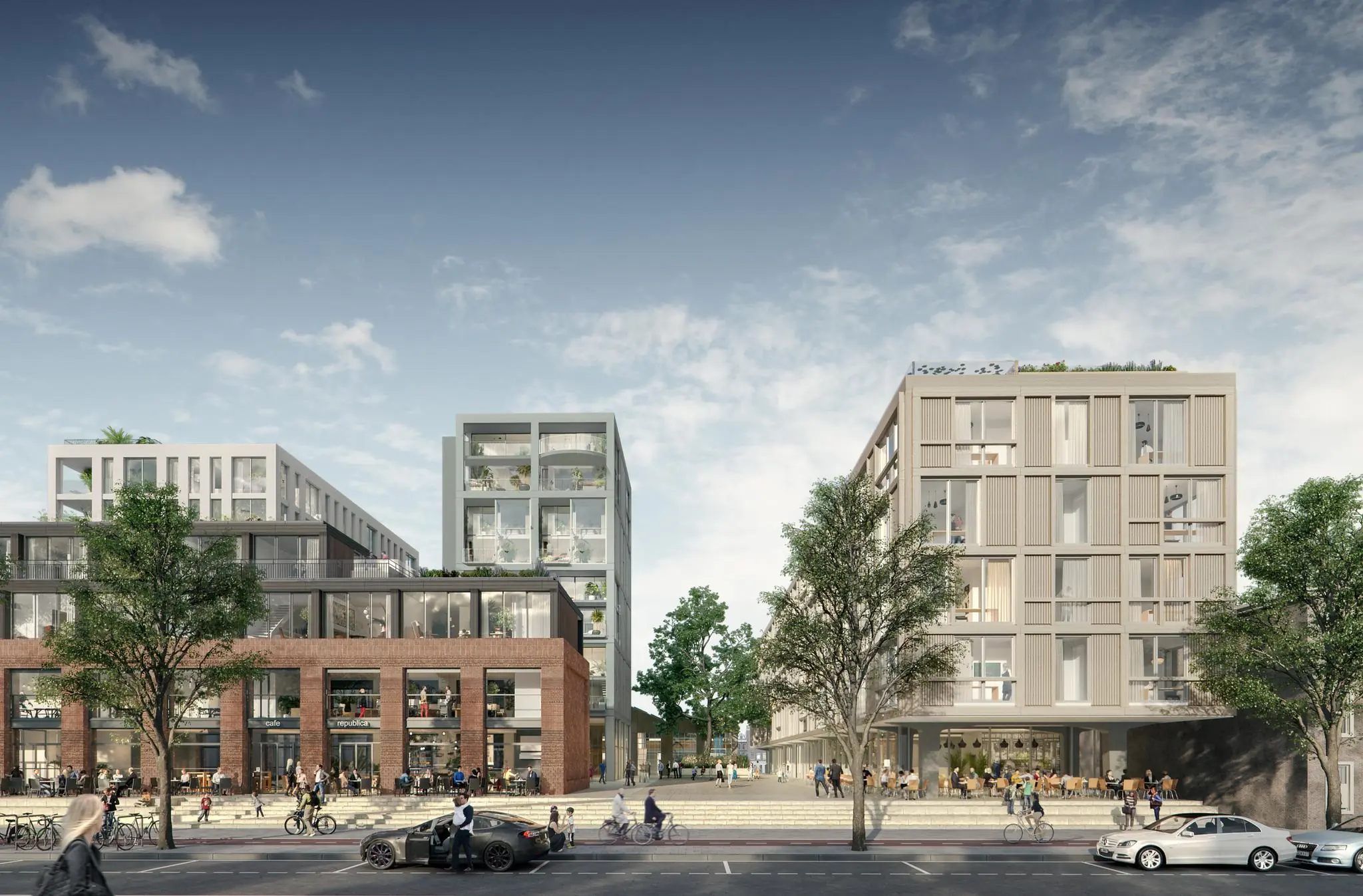 Moderne nieuwbouw aan de Papaverweg met appartementen, horeca en een levendige straat met voetgangers en fietsers.