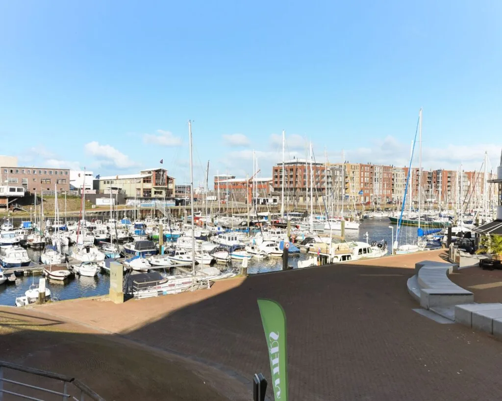 Zicht op jachthaven met aangemeerde boten aan de Dr. Lelykade 257 in Den Haag, omringd door moderne gebouwen.