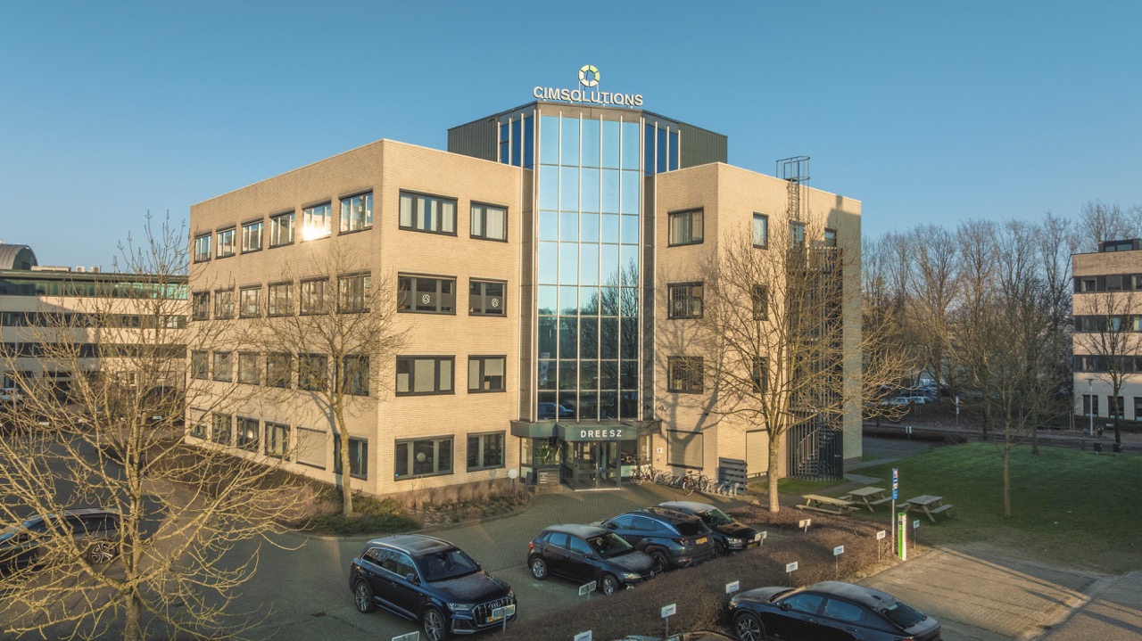 Vooraanzicht van het kantoorpand van CIMsolutions en Dreesz op een zonnige dag.