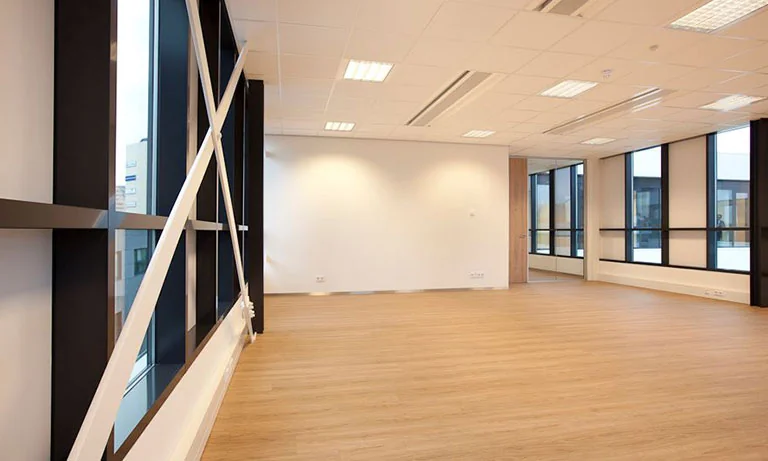 Licht en modern kantoorpand aan De Boelelaan met grote ramen en houten vloer.