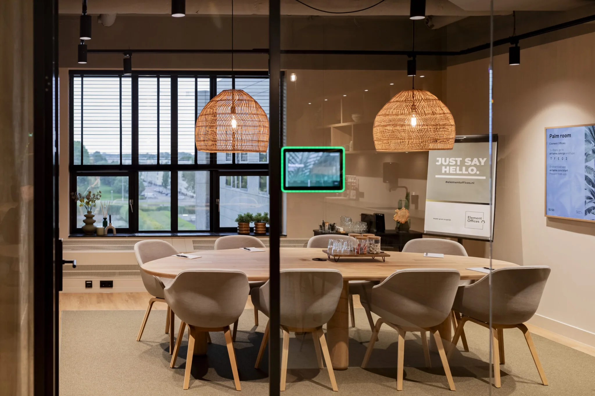 Vergaderruimte "Palm room" in Element Offices Diemen met ronde tafel, moderne stoelen en warme verlichting.
