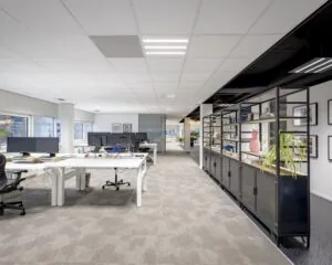 Moderne, ruime kantoorruimte met werkplekken en open kasten aan de Hogehilweg 8.