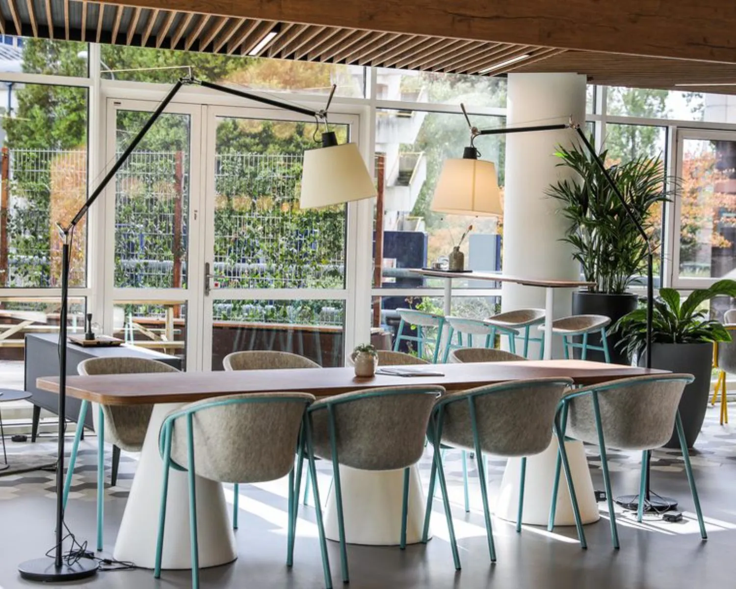 Moderne kantoorruimte aan de PJ Oudweg 41 in Almere met een grote houten vergadertafel, designstoelen en veel natuurlijk licht.