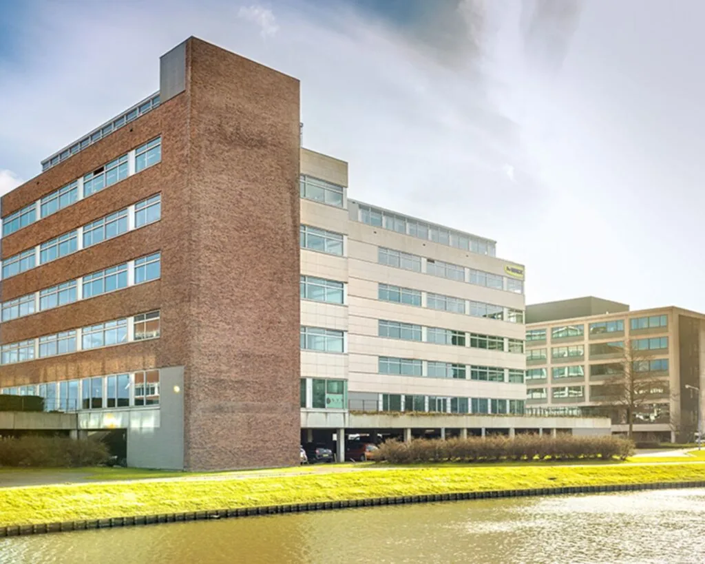 Moderne kantoorgebouwen aan de Tupolevlaan 41 in Schiphol, gelegen aan een waterpartij.