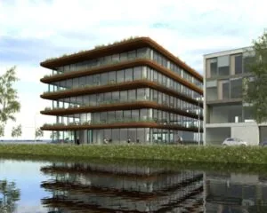 Modern kantoorgebouw aan het water aan de Danzigerkade 207 in Amsterdam met glazen gevel en groene terrassen.