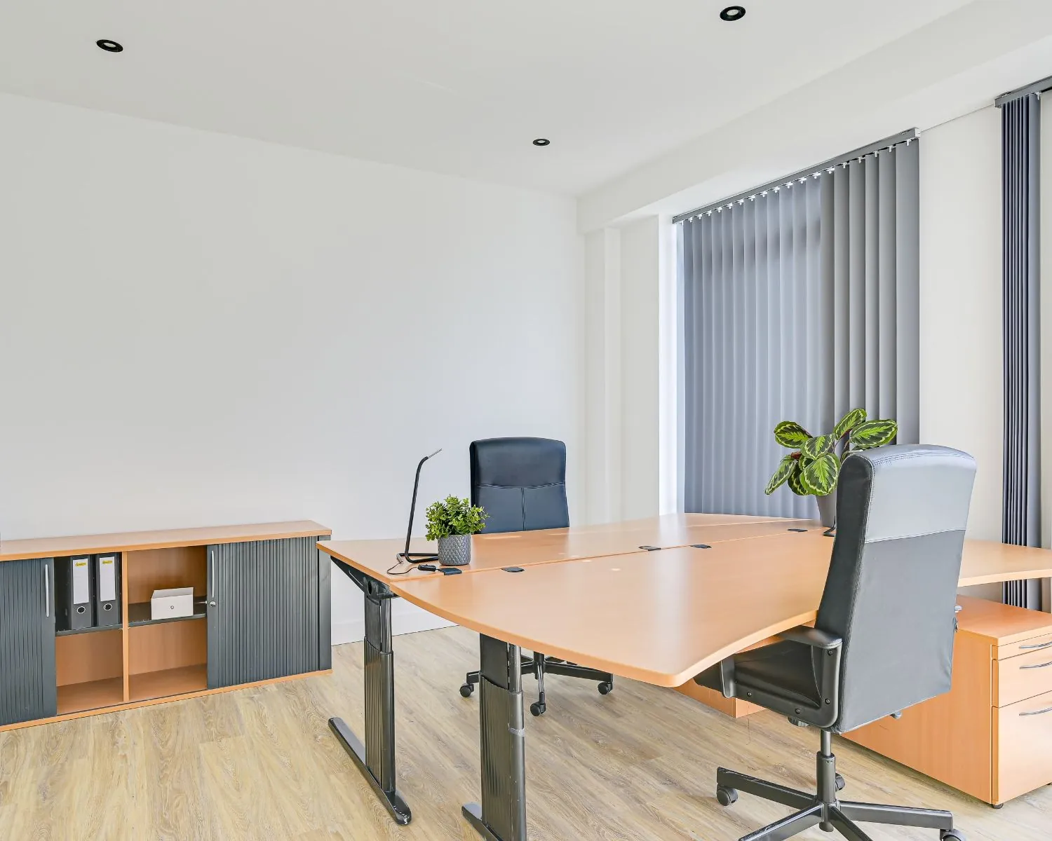 Moderne en lichte kantoorruimte met twee bureaus, draaistoelen en grote raampartijen aan Tijnmuiden 89 in Amsterdam.