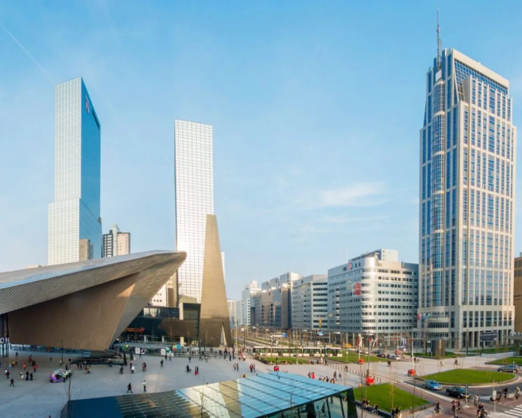 Modern zakendistrict in Rotterdam met het kantoorgebouw Weena 690 en het Centraal Station op de voorgrond.