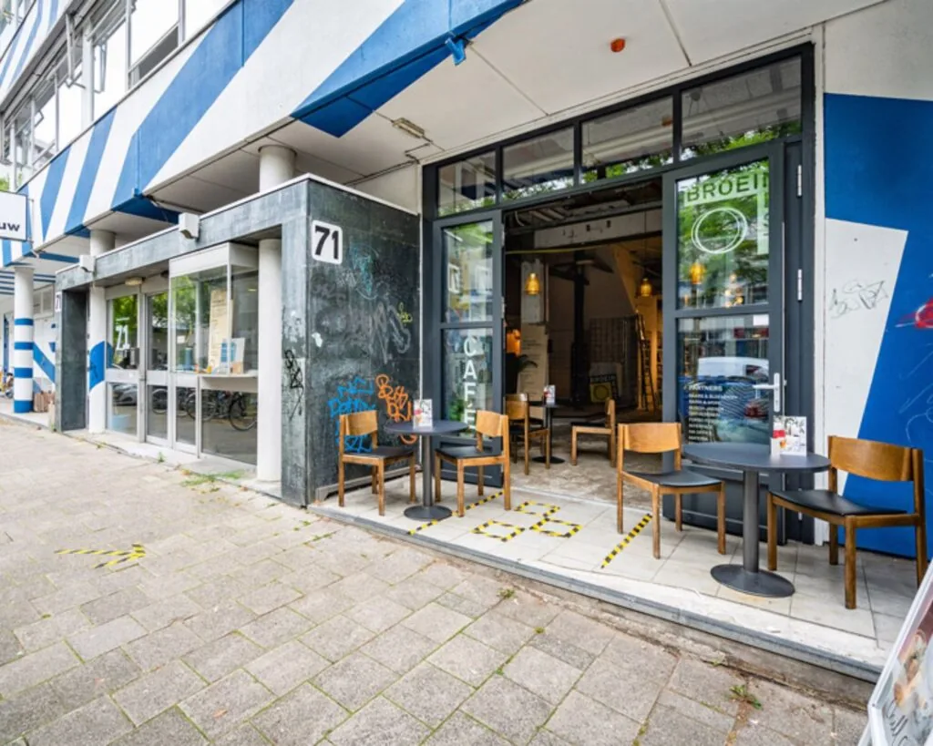 Vooraanzicht van kantoorruimte en café Broei aan de Zomerhofstraat 71 in Rotterdam met terras en zitplaatsen buiten.