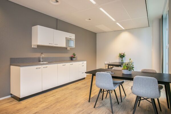 Moderne pantry en zithoek in een kantoorruimte aan de Cuserstraat 91 in Amsterdam.