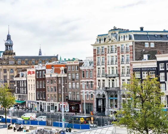 Gevelaanzicht van kantoorpand aan de Prins Hendrikkade 21 in Amsterdam met omliggende historische gebouwen.