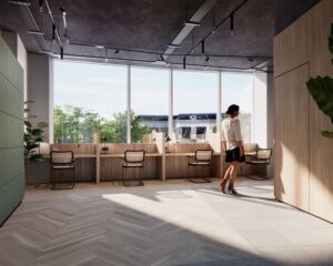 Moderne kantoorruimte in Leeuwarden met werkplekken aan het raam en een vrouw die voorbij loopt.
