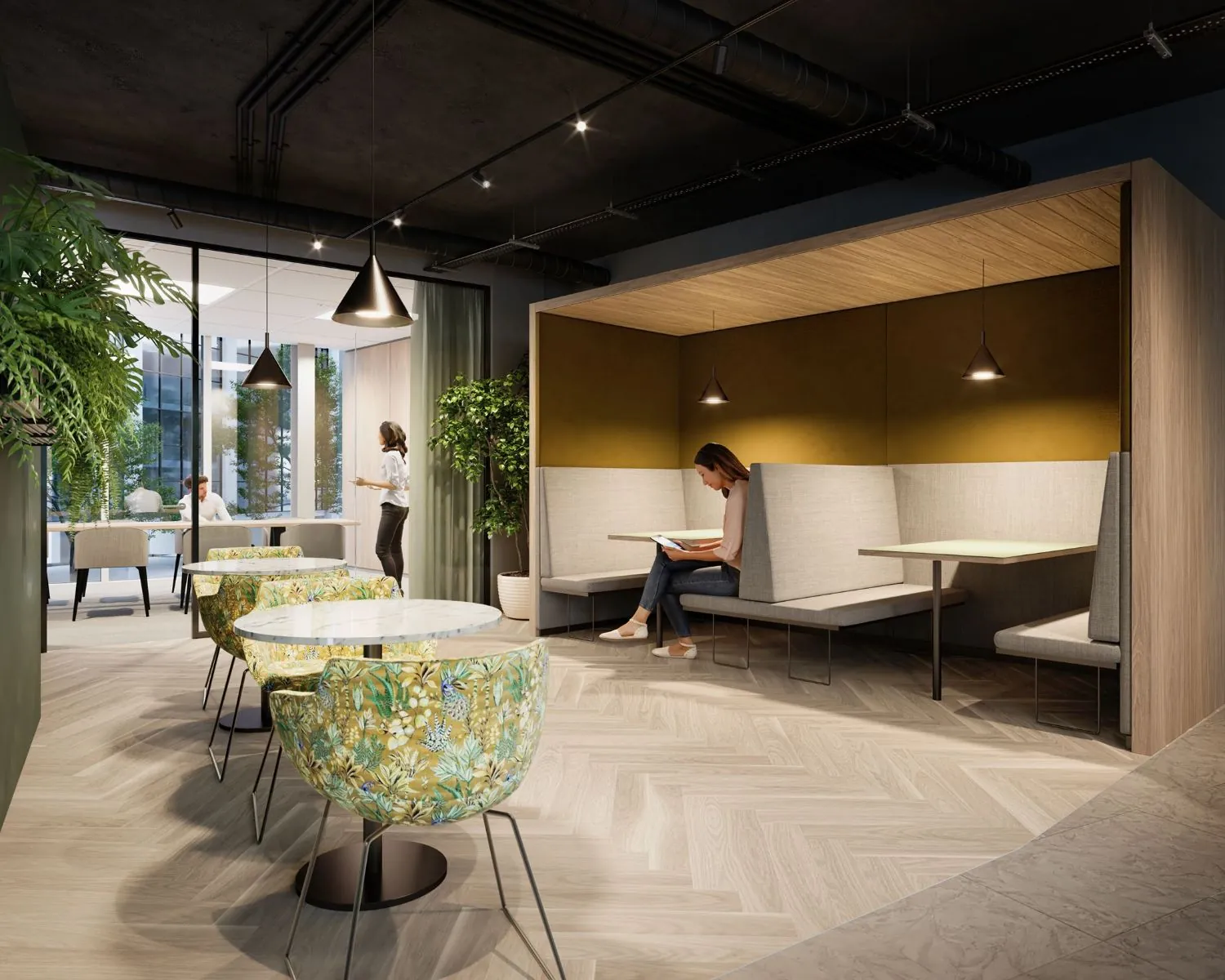 Moderne kantoorruimte in Leeuwarden met zitjes, planten en een werkende vrouw in een nis.