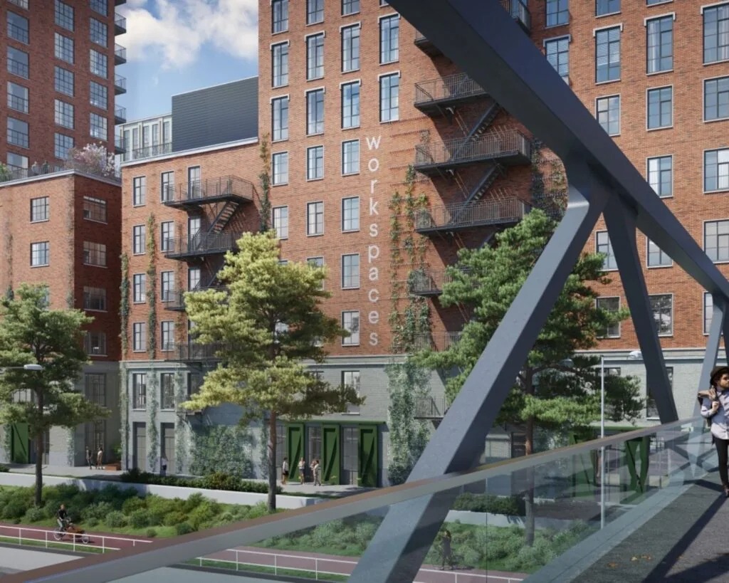 Kantoorruimte aan de Karl Weisbardstraat in Rotterdam met rode bakstenen gevel en buitentrappen, gezien vanaf een voetgangersbrug.