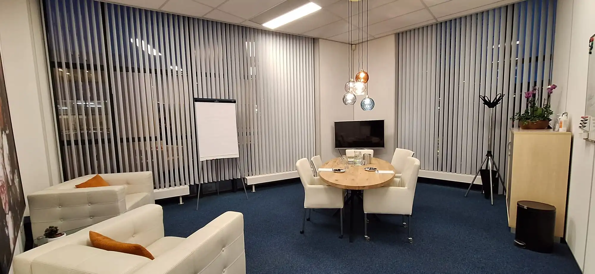 Moderne vergaderruimte aan de Leeghwaterstraat 25 in Reeuwijk met ovale tafel, comfortabele stoelen, flip-over en televisie.