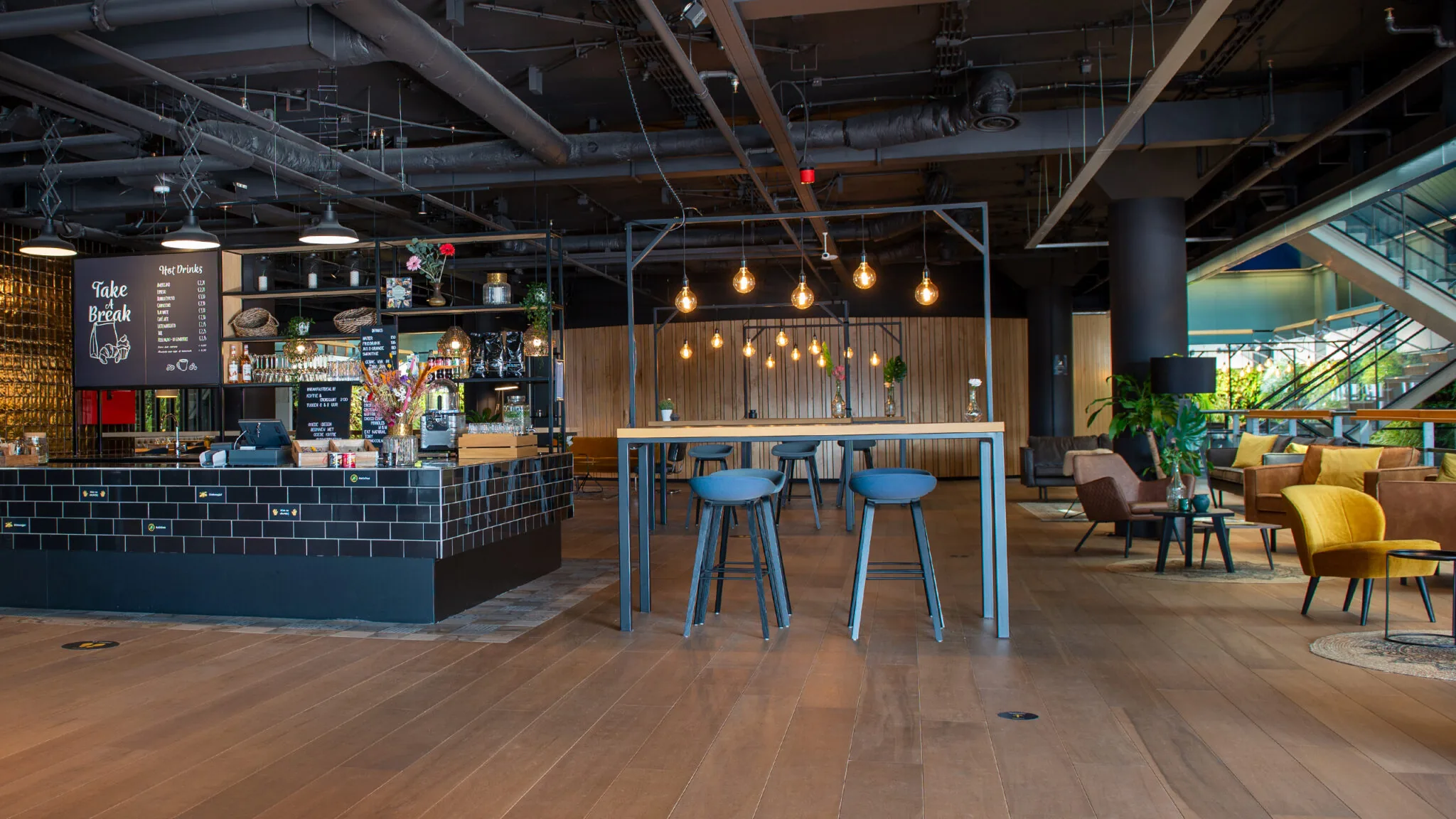 Moderne, sfeervolle kantoorlounge met koffiebar en zitgedeelte in Flight Forum 760 in Eindhoven.