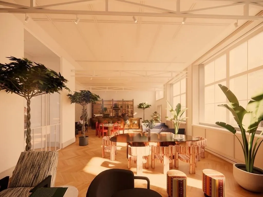 Lichte en moderne kantoorruimte aan de Keizersgracht 264 in Amsterdam met grote ramen, planten en kleurrijk meubilair.