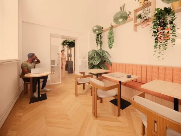 Moderne, lichte kantoorruimte aan de Keizersgracht 264 in Amsterdam met houten vloer, zitplekken, laptops en hangende planten.