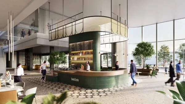 Modern ingerichte lobby van Koningin Wilhelminaplein 4 met centraal gelegen koffiebalie van DeliDish en veel natuurlijk lichtinval.