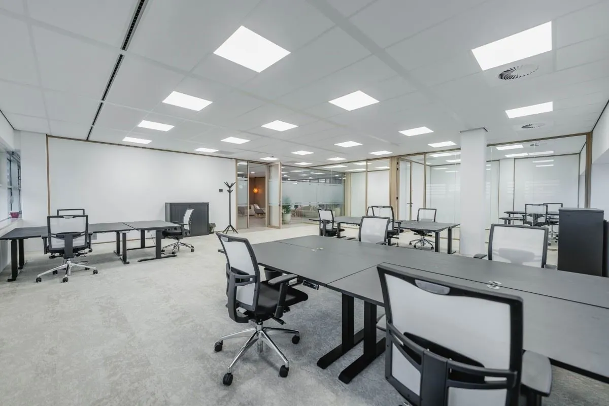 Licht en modern ingericht kantoorpand aan de Laarderhoogtweg 7 met open werkplekken en glazen scheidingswanden.