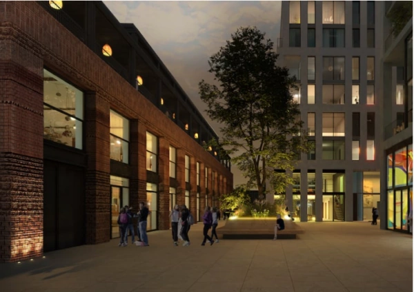 Avondbeeld van Papaverweg 37B met mensen op een modern plein tussen een oud bakstenen pand en een nieuw wit gebouw.