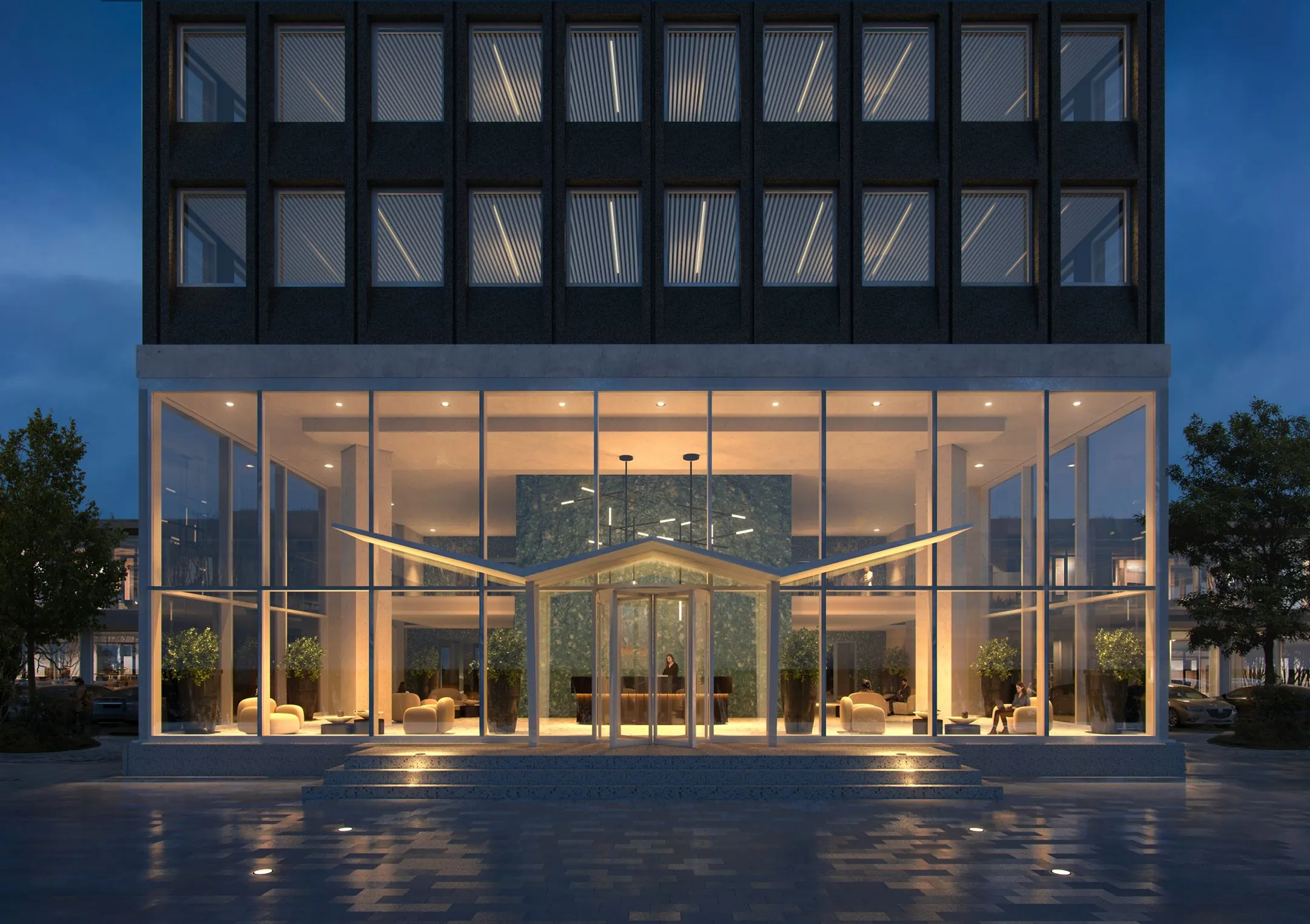 Verlichte entree van een modern kantoorgebouw aan de Rijnsburgstraat 9 tijdens de avond.