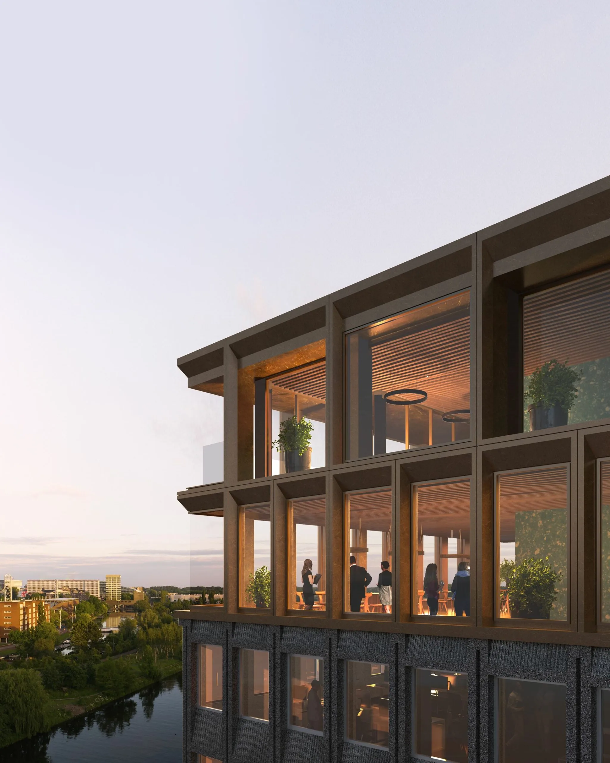Moderne gevel van het gebouw aan de Rijnsburgstraat 9 met grote ramen en mensen in een sfeervol verlichte ruimte met uitzicht op het water.