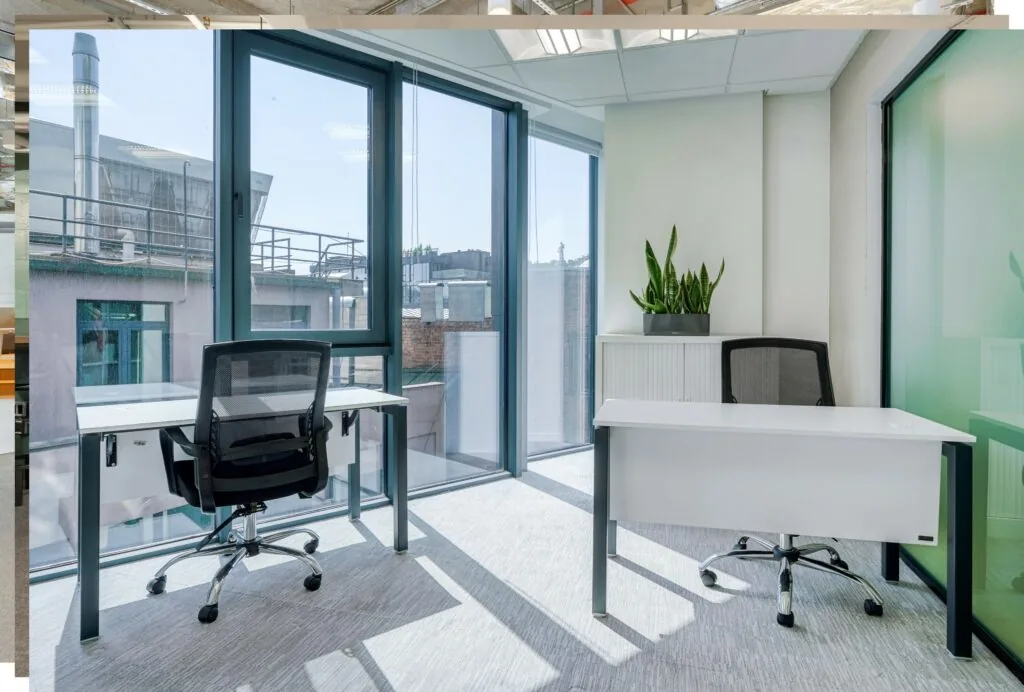 Modern licht kantoor met twee bureaus en grote ramen in Rotterdam Airportplein 22.