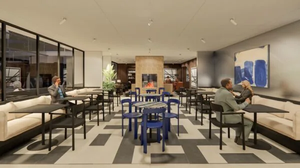 Moderne lounge- en werkruimte in Strawinskylaan 1 met zitplaatsen, een open haard en kunst aan de muur.