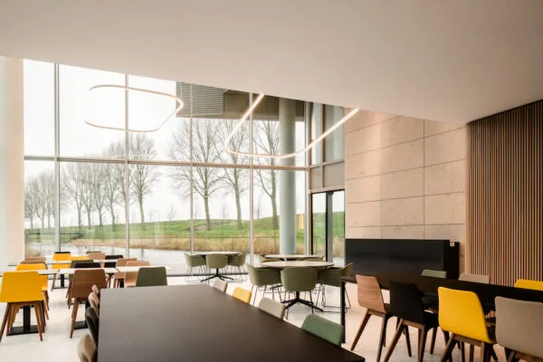 Moderne en lichte zitruimte in de Zuidtoren hall met grote ramen en uitzicht op bomen en water.