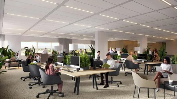 Open kantoorruimte in entree201_5 met meerdere mensen aan het werk tussen groene planten en moderne bureaus.