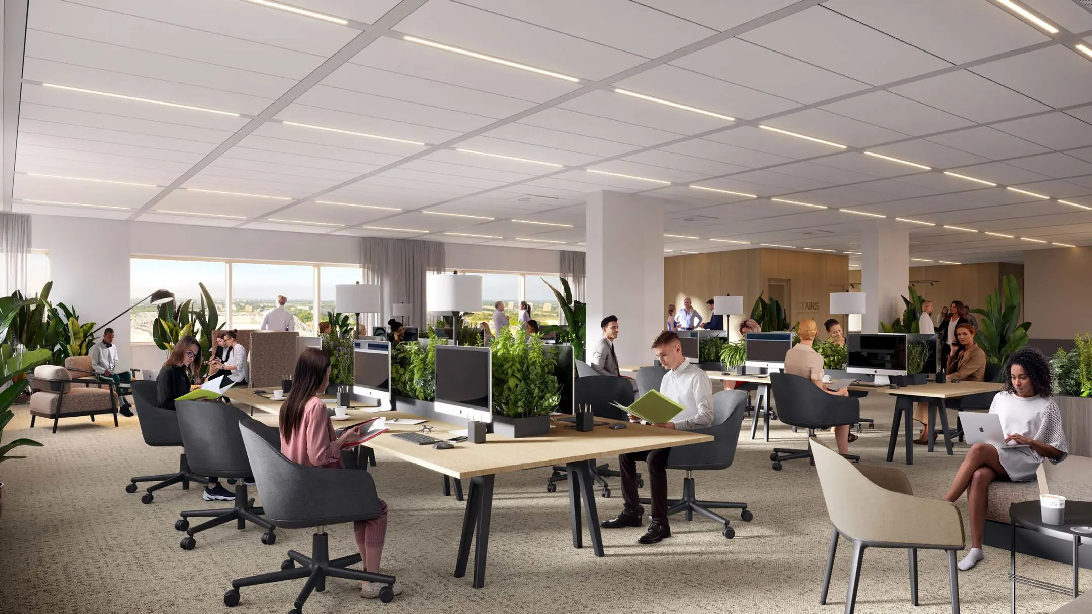 Open kantoorruimte in entree201_5 met meerdere mensen aan het werk tussen groene planten en moderne bureaus.