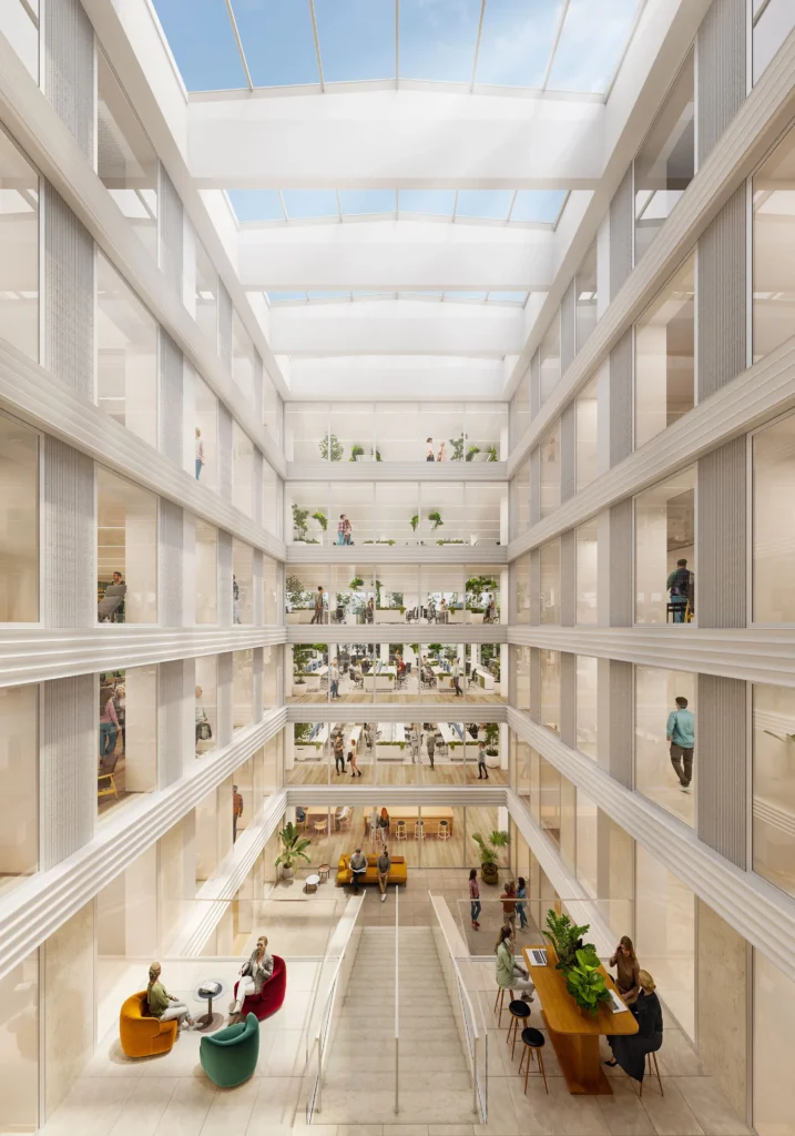 Licht atrium van Herengracht 206 met meerdere verdiepingen kantoren en ontmoetingsruimtes onder een glazen dak.