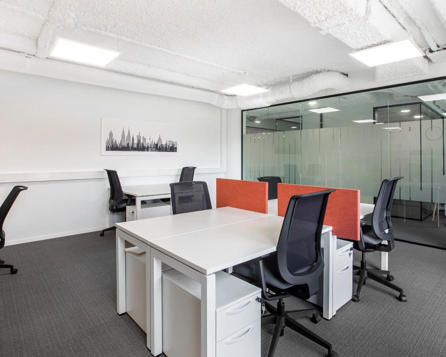 Moderne kantoorruimte met bureaus, bureaustoelen en glazen scheidingswand aan het Stationsplein 13A in Amersfoort.