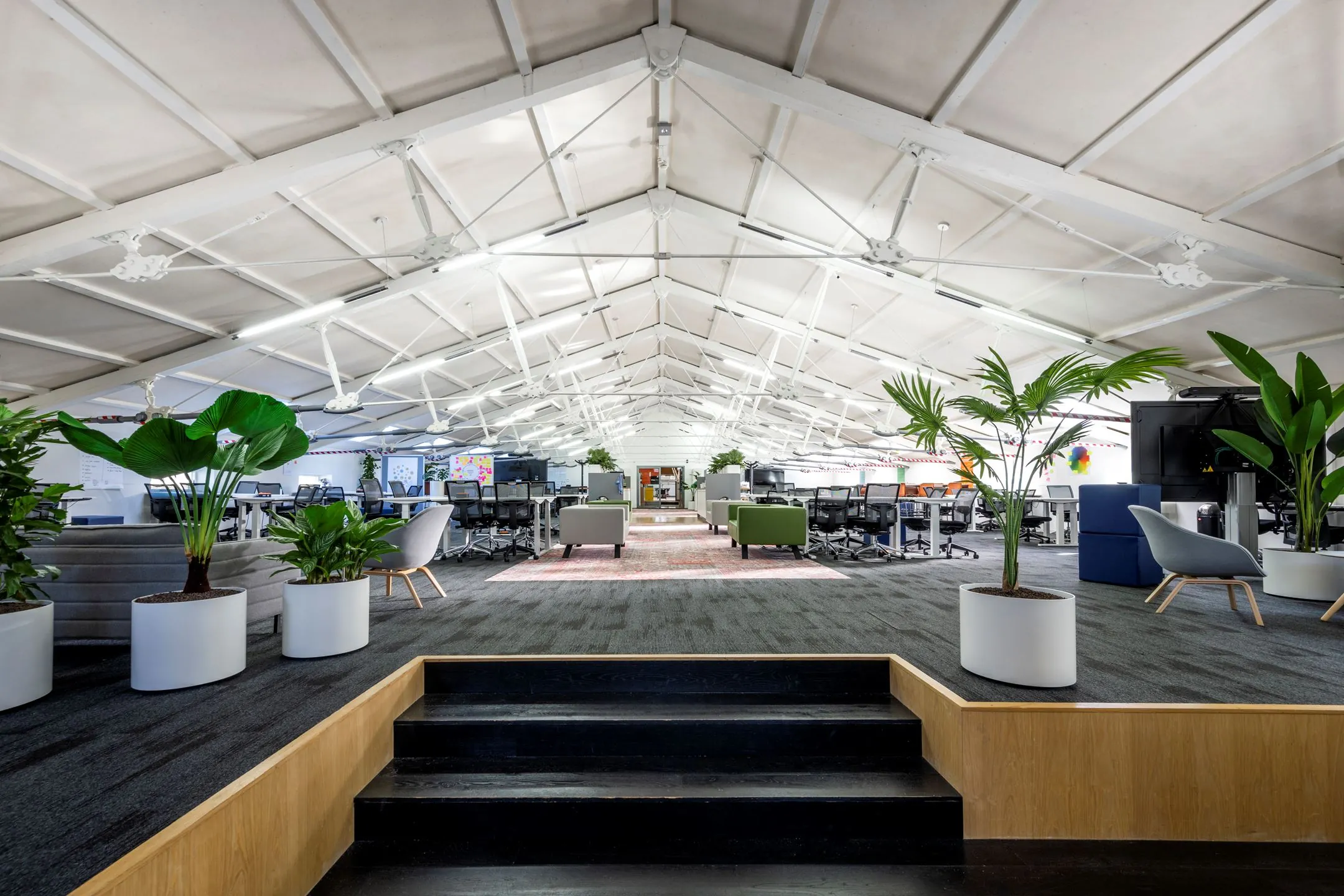 Moderne en open kantoorruimte met veel licht, werkplekken en groen bij De Bell, Sarphatistraat 370.