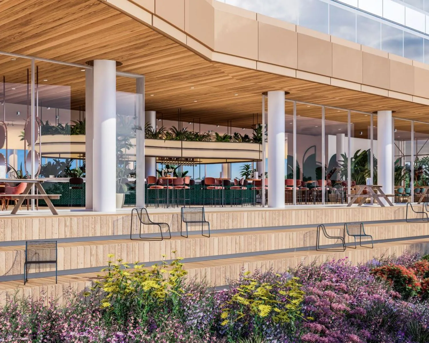 Moderne kantoorruimte te huur aan het Mercuriusplein in Hoofddorp met glazen gevel, houten terras en kleurrijke beplanting.