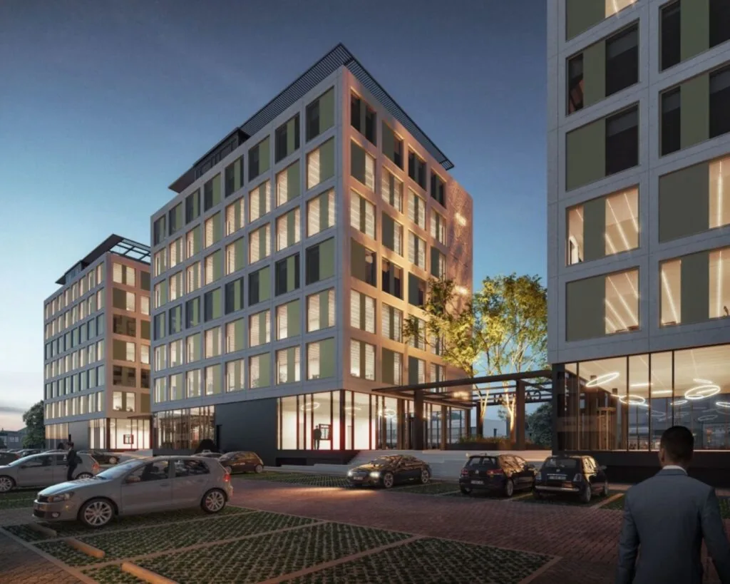 Moderne kantoorgebouwen aan de Jan van Krimpenweg bij schemering met parkeerplaatsen op de voorgrond.