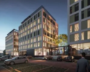 Moderne kantoorgebouwen aan de Jan van Krimpenweg bij schemering met parkeerplaatsen op de voorgrond.