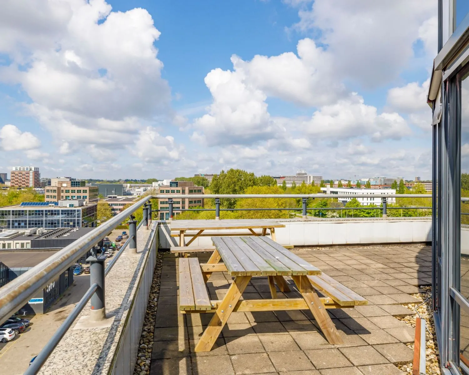 Dakterras met picknicktafels en uitzicht over kantoren aan de Overschiestraat in Amsterdam.