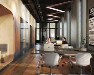 Moderne kantoorruimte aan de Oostenburgermiddagstraat 601 met open werkplekken, glazen wanden en een warme houten vloer.