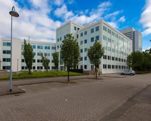 Modern kantoorgebouw aan de Saturnusstraat 46 in Hoofddorp met meerdere verdiepingen en omringd door bomen en parkeerplaatsen.