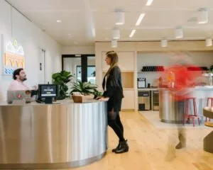 Moderne kantoorruimte aan de Strawinskylaan met receptiebalie, open keuken en zithoeken.