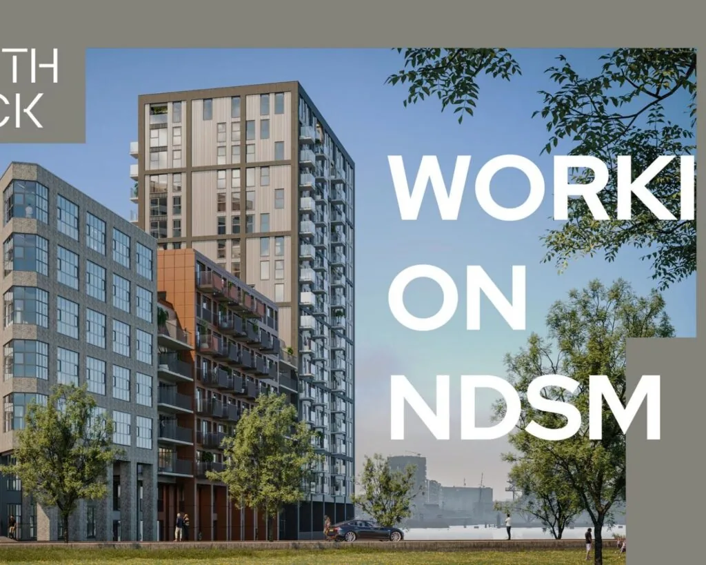 Moderne kantoorgebouwen aan de NDSM-pier in Amsterdam met uitzicht op het water en omliggende groen.