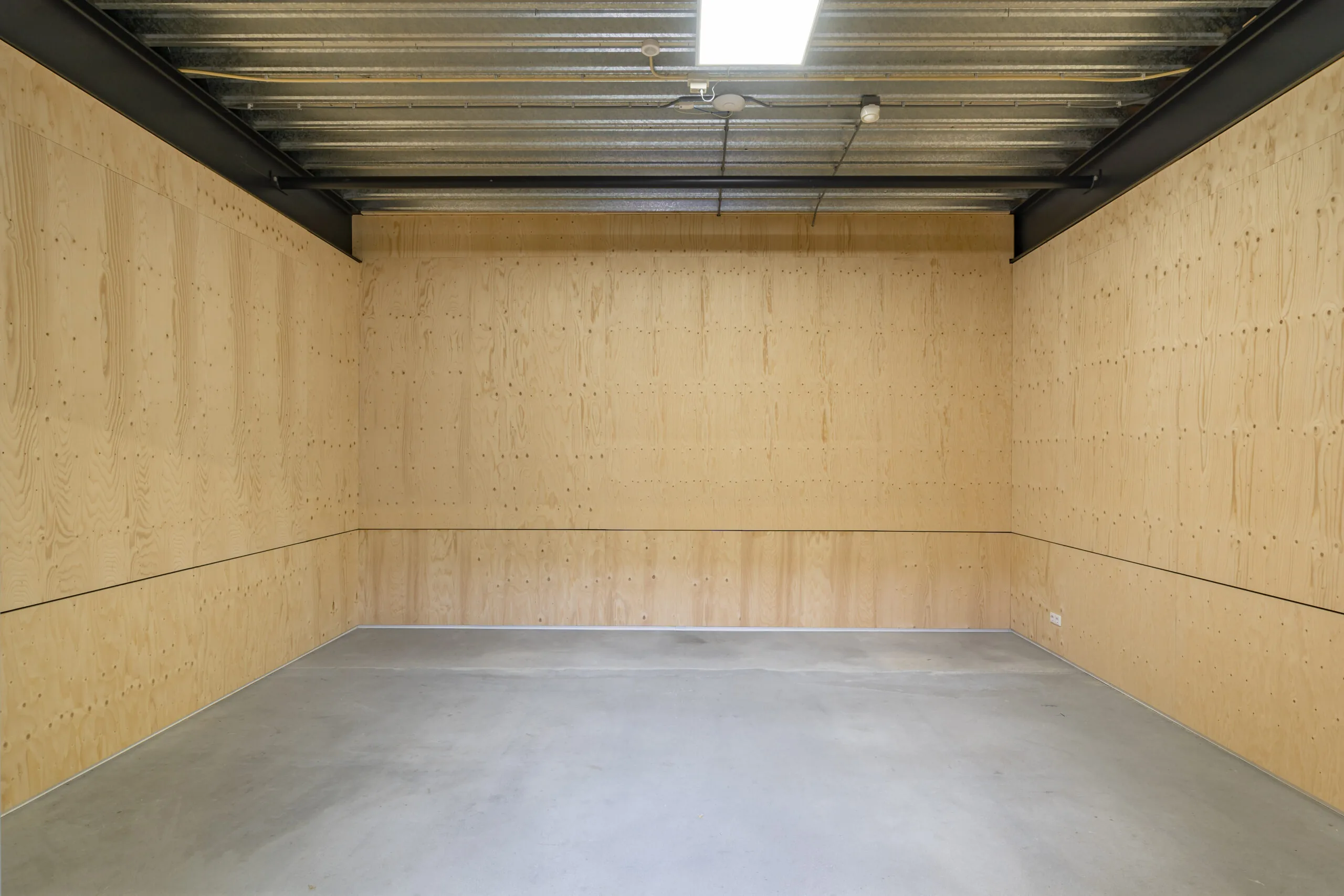 Lege kantoorruimte met houten wanden, betonnen vloer en metalen plafond in Hoofdveste 2, Houten.