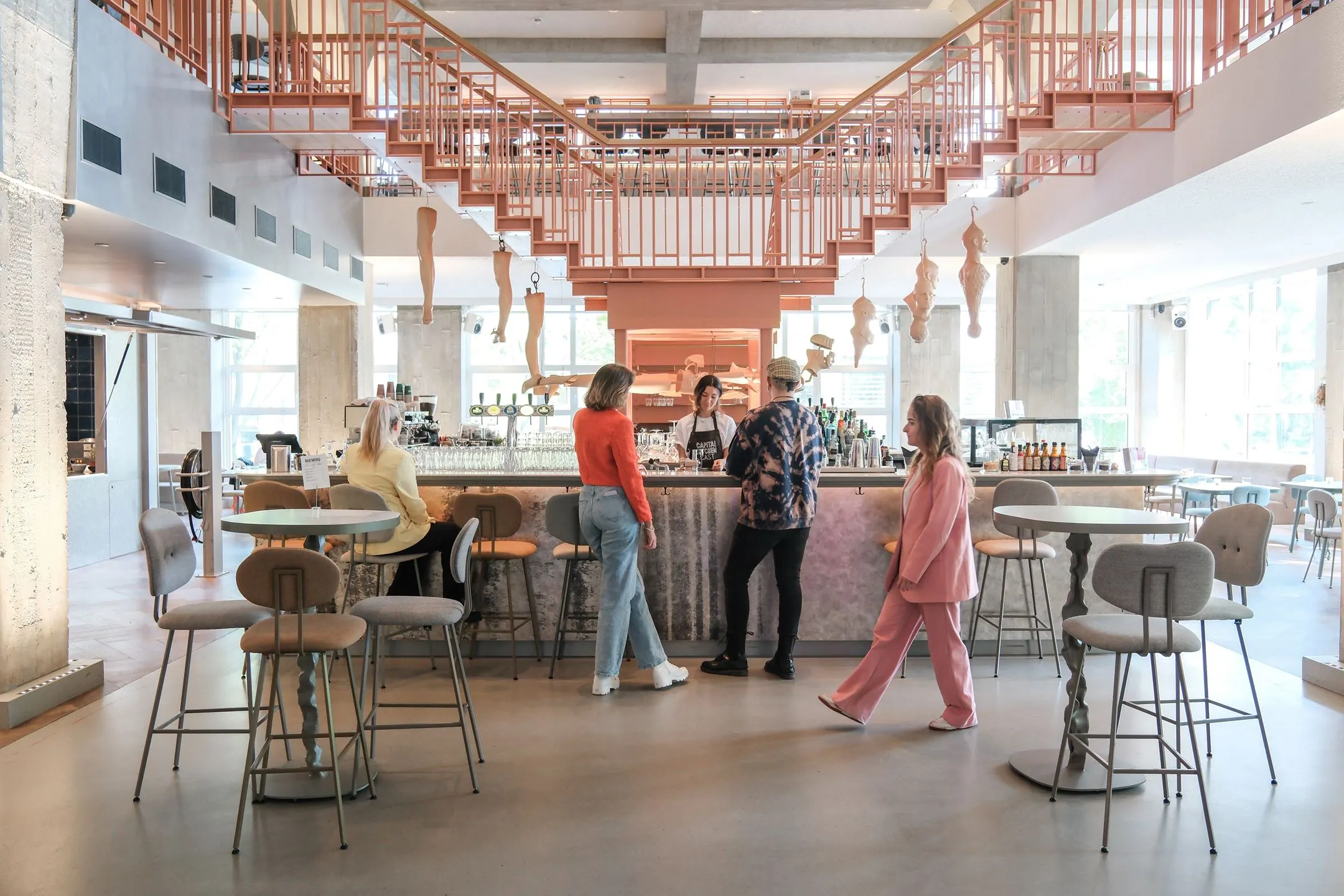 Moderne en lichte barruimte in een kantoor aan het Weesperplein 4A in Amsterdam met mensen aan de balie en zitgelegenheid.