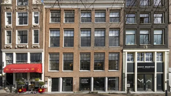 Voorgevel van een statig grachtenpand aan de Keizersgracht 467 met meerdere bedrijven op de begane grond, waaronder een interieur fotogalerij en kantoorruimte te huur.