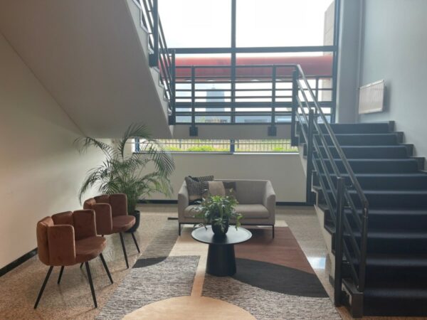 Moderne wachtruimte bij de trap in kantoorpand Markerkant in Almere, met zitmeubels, planten en grote ramen.