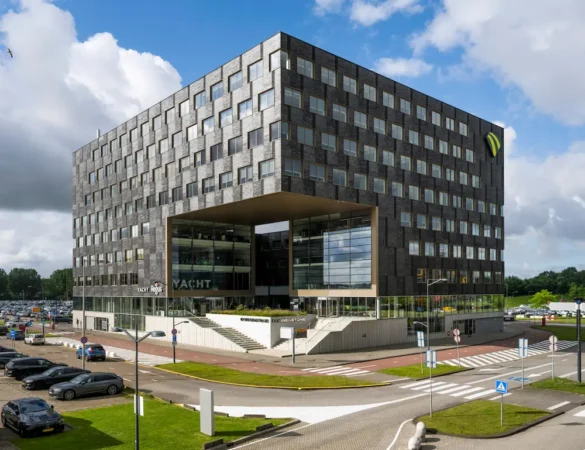 Modern office building near Rotterdam The Hague Airport with a distinctive square opening in the center.